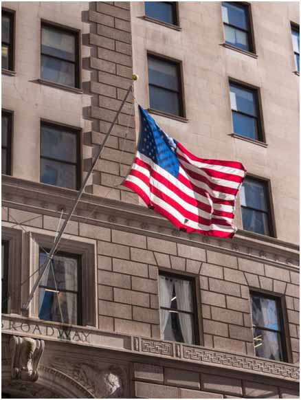 The US flag hanging off a building